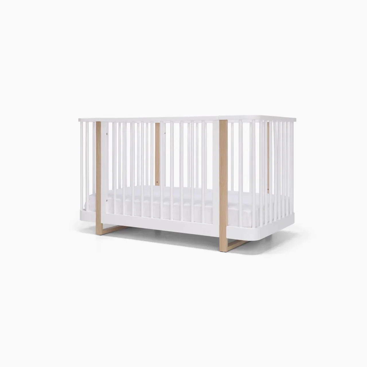 White and wood Tasman Eco Pisa baby crib with dresser, perfect for Toshi baby rooms