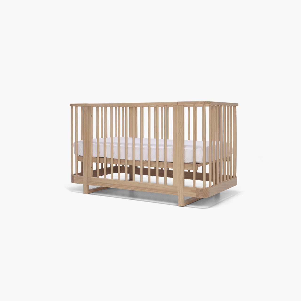 Wooden baby crib from Tasman Eco Pisa with Toshi Baby and baby strollers in the background