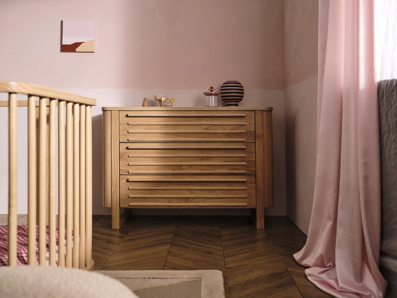 Wooden dresser with slatted drawers for stylish storage, ideal alongside baby strollers