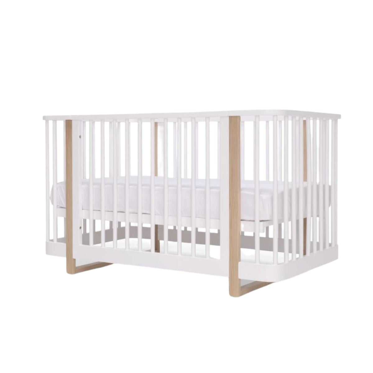 White and wood Tasman Eco Pisa Cot with free mattress, perfect for Toshi Baby nursery