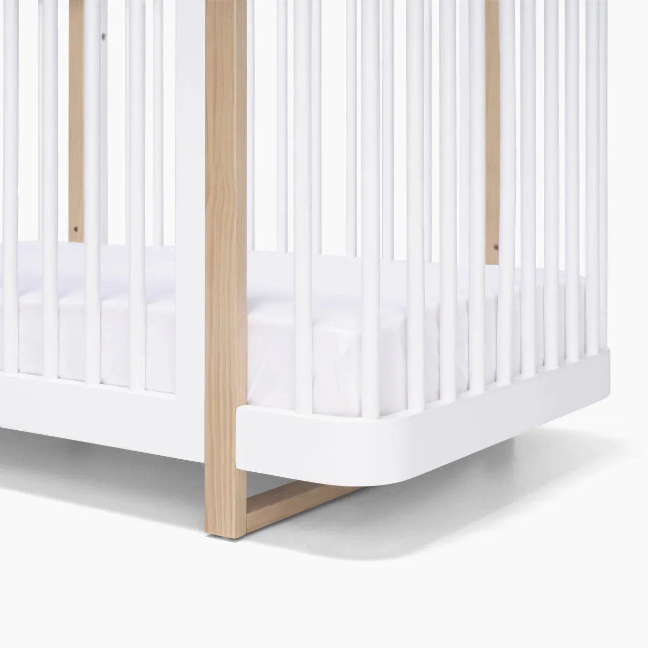 White and wood Tasman Eco Pisa baby crib with free standard mattress from Toshi Baby