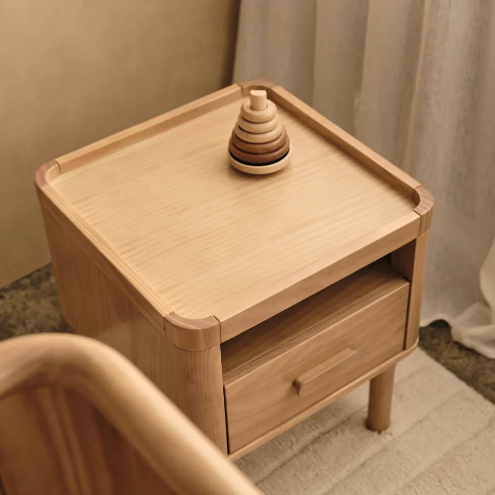 Tasman Eco Willow nightstand with drawer and Toshi Baby stacking toy, maintaining classic design