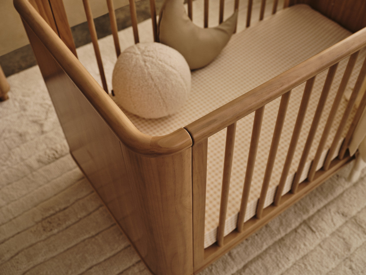 Wooden baby crib from Tasman Eco Willow Cot, perfect for cozy nursery setups