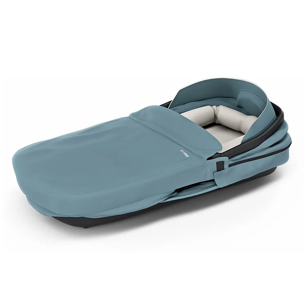 Blue baby bassinet from Thule Urban Glide 3 perfect with Toshi baby romper and Odyssey wagon wheels