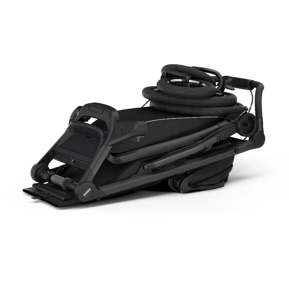 Folded black Thule Urban Glide 4-Wheel All-Terrain Stroller for easy storage