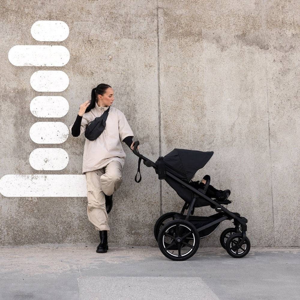 Black baby stroller Thule Urban Glide 4-Wheel All-Terrain Stroller with twist hand brake