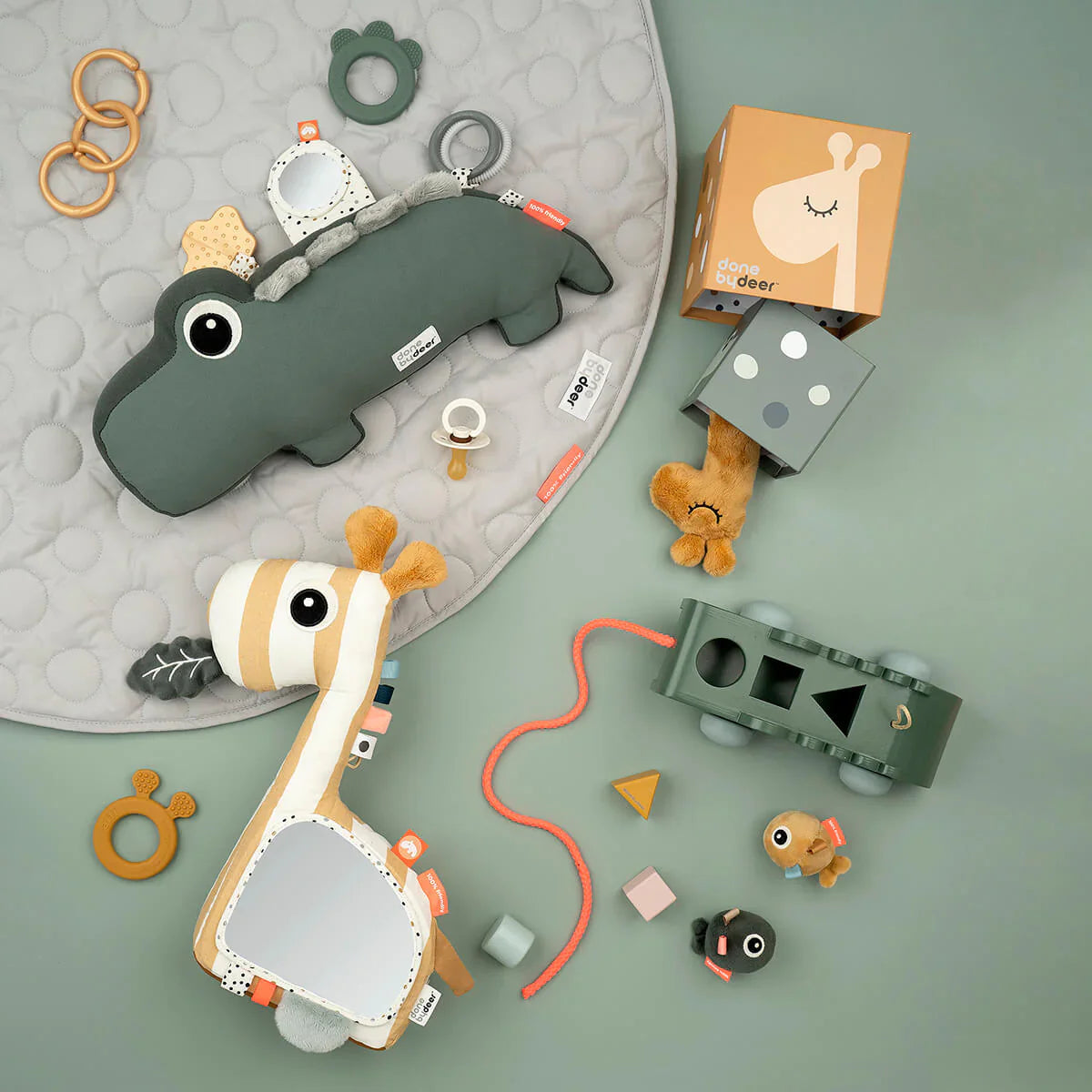 Assorted baby toys in Done by Deer Croco Pull-Along Sorting Box for baby strollers and more