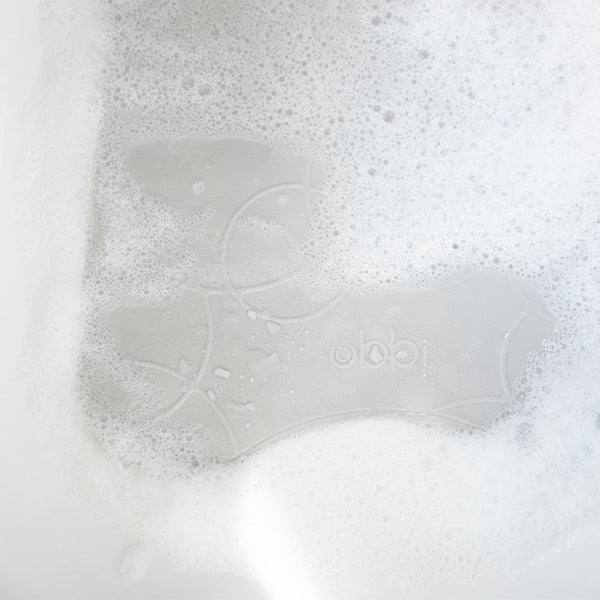 Ubbibathmat Grey to prevent slips in your bathroom with a comfy white bath mat