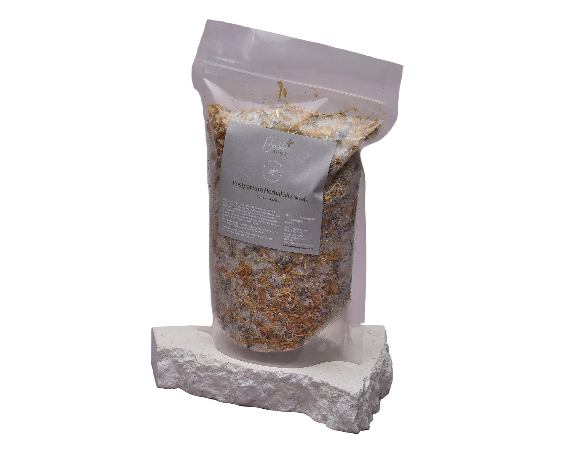 Bag of peppermint herbal mix on a stone surface with a gray background