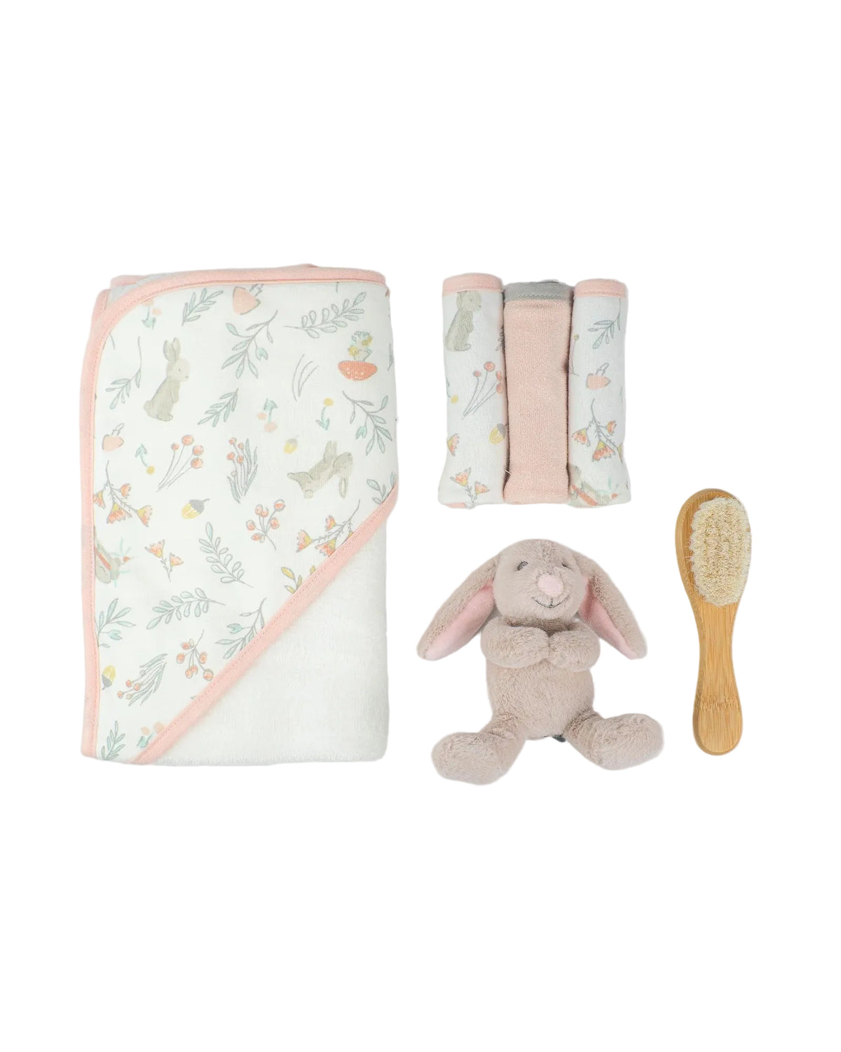 A baby gift set featuring a white hooded blanket with a pastel bunny and floral print, a matching folded cloth napkin, a plush bunny toy, and a wooden baby brush, arranged on a light gray background.