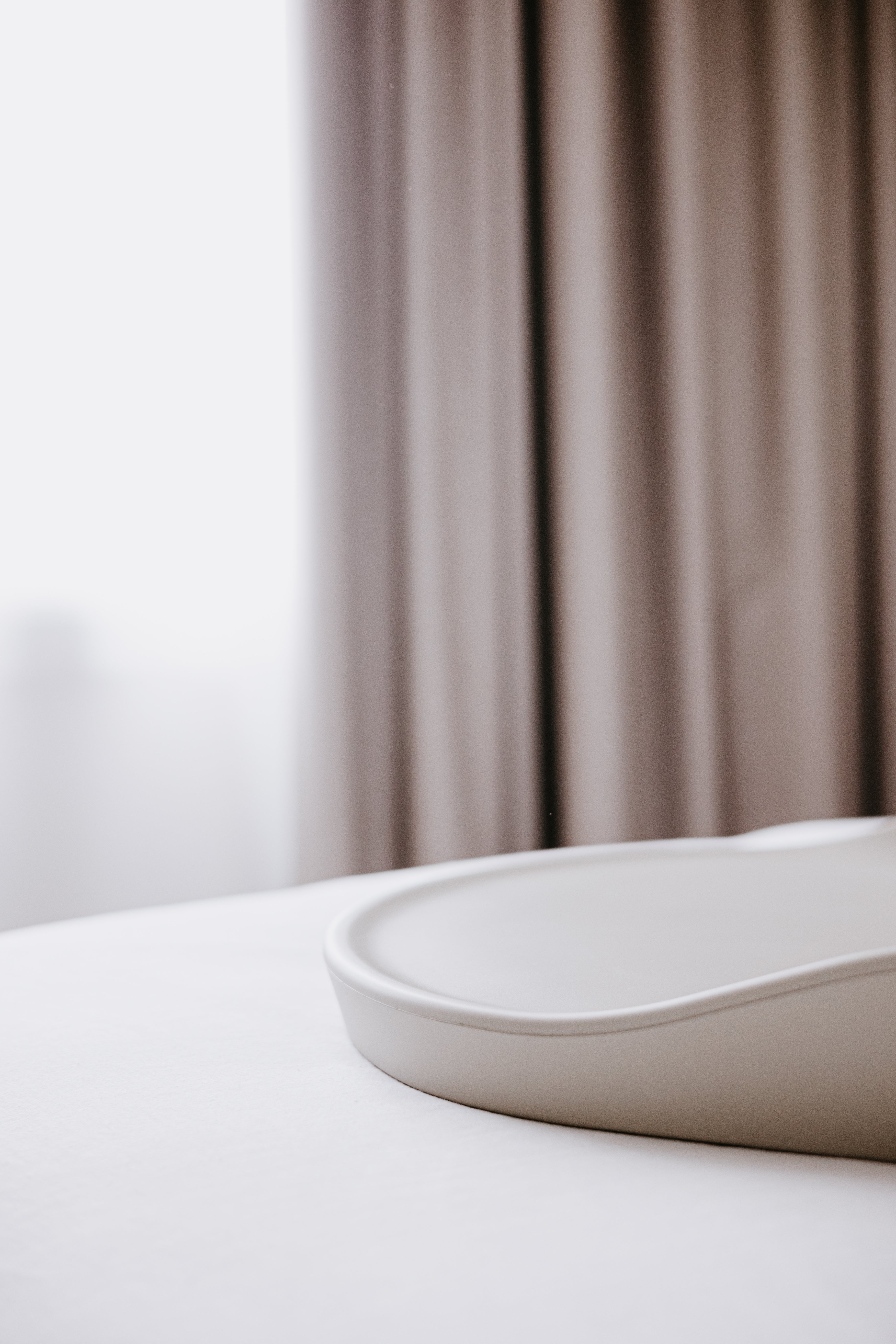 White curved ceramic basin from Tasman Eco Touzy Change Mat for baby strollers