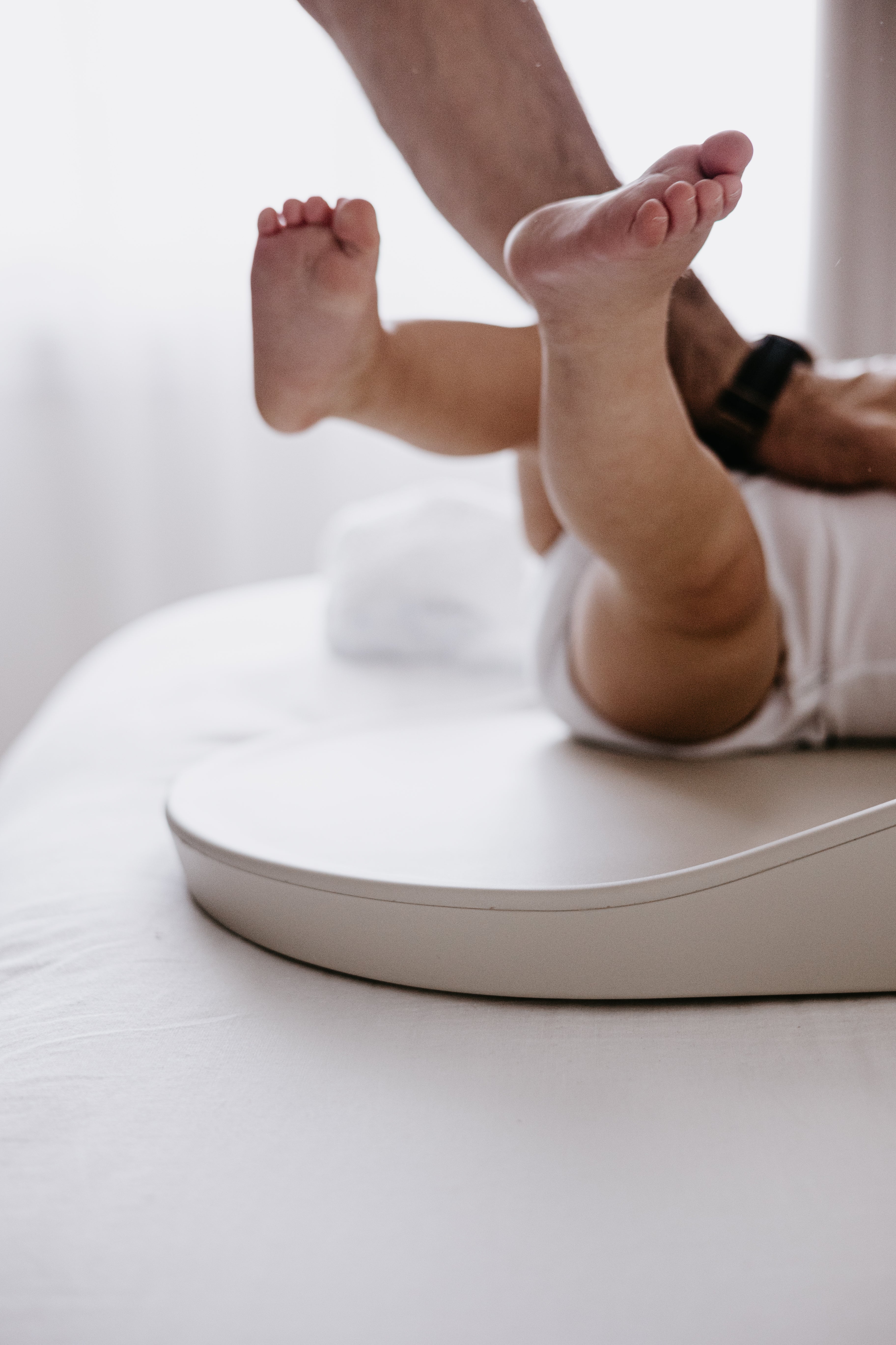 Baby on scale with Tasman Eco Touzy Change Mat Toshi Baby for easy weight checks