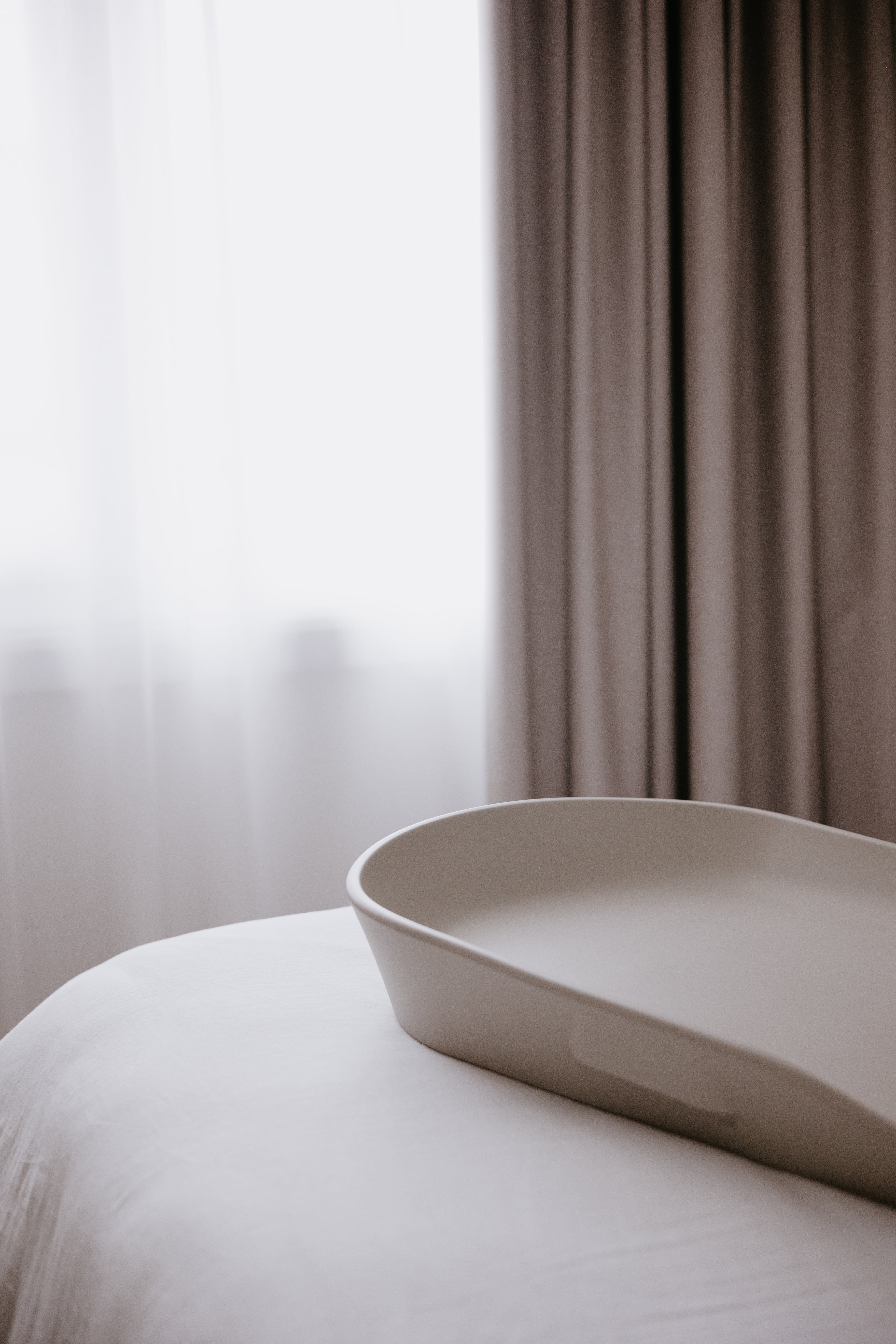 White curved shallow basin on Tasman Eco Touzy Change Mat for baby strollers