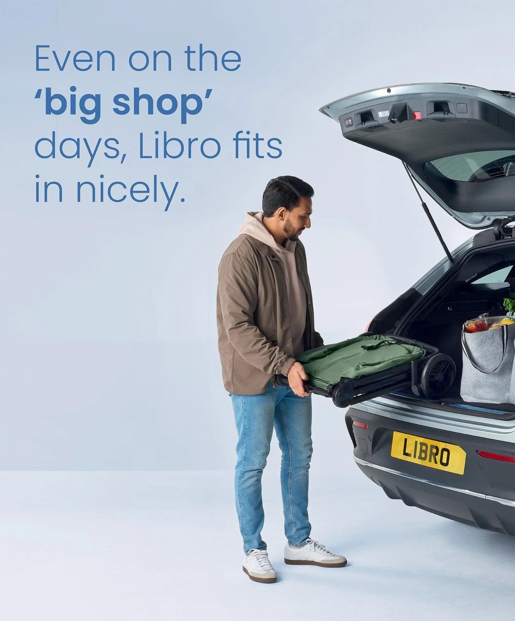 Folded green shopping trolley with Mamas&Papas Libro Stroller Bay Green and lay-flat seat recline features