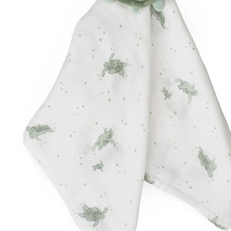 White fabric with green turtle pattern on a white background